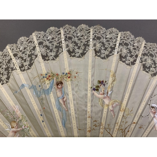 50 - c1890s, a large incised bone fan, the cream silk leaf painted with winged cherubs carrying fruits an... 