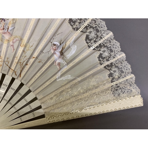 50 - c1890s, a large incised bone fan, the cream silk leaf painted with winged cherubs carrying fruits an... 