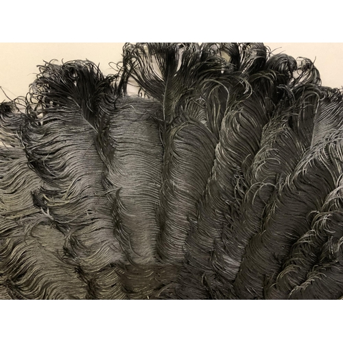 104 - A large and showy black ostrich feather fan, the feathers mounted on tortoiseshell, fitted with a wi... 