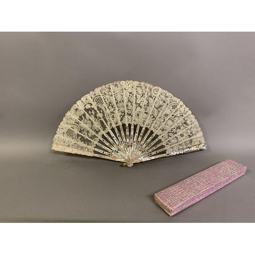 81 - An early 20th century pink mother of pearl fan, the monture carved, pierced and gilded, the leaf of ... 