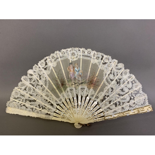 84 - An early 20th century Brussels tape lace fan with central painted gauze depiction of a courting coup... 