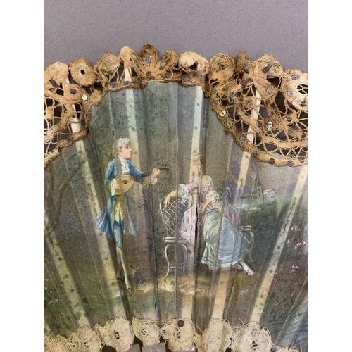 84 - An early 20th century Brussels tape lace fan with central painted gauze depiction of a courting coup... 