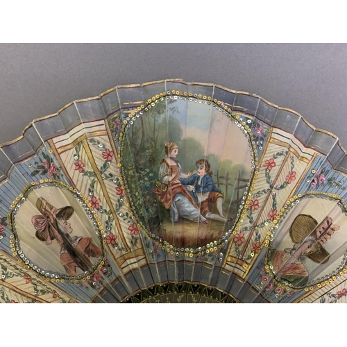 53 - An attractive early 20th century silk fan with double leaf, the recto painted with a cartouche of a ... 