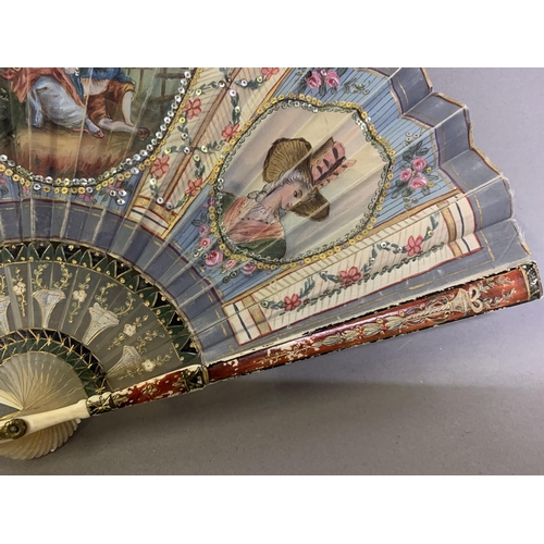 53 - An attractive early 20th century silk fan with double leaf, the recto painted with a cartouche of a ... 