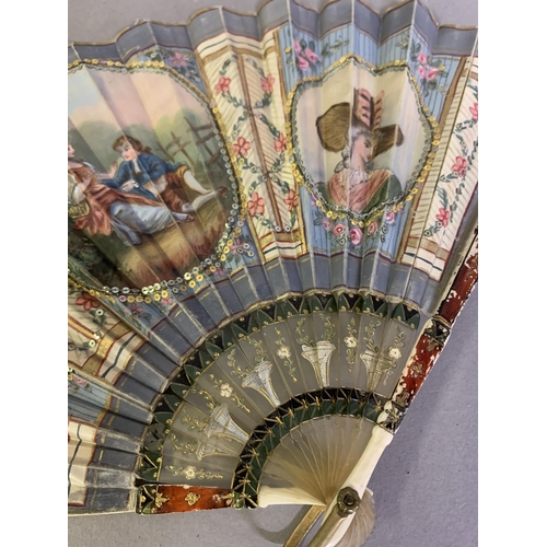 53 - An attractive early 20th century silk fan with double leaf, the recto painted with a cartouche of a ... 