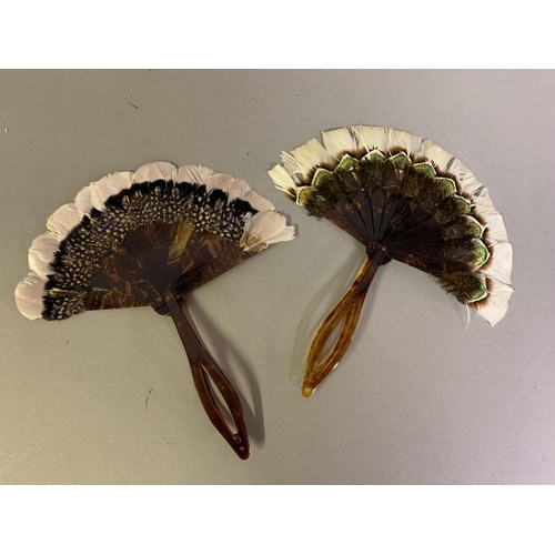 110 - Two small 19th century marquetry feather fans of the type using game feathers, both faux tortoiseshe... 