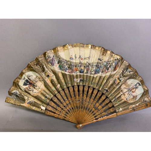 58 - A good, large  c 1890’s bone fan, mounted with a deep silk leaf, painted with an informal gathering ... 