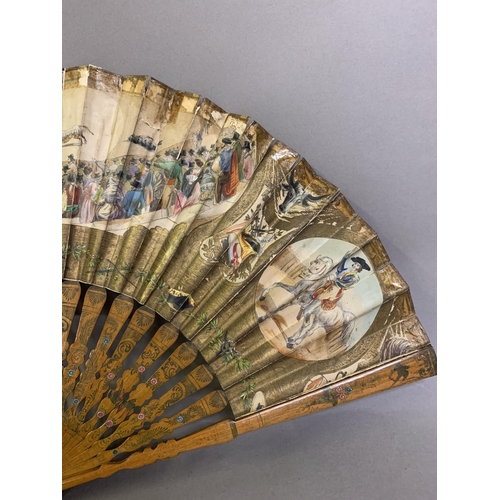 58 - A good, large  c 1890’s bone fan, mounted with a deep silk leaf, painted with an informal gathering ... 