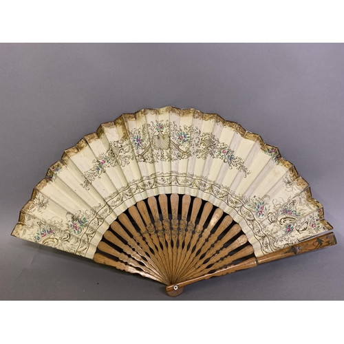 58 - A good, large  c 1890’s bone fan, mounted with a deep silk leaf, painted with an informal gathering ... 