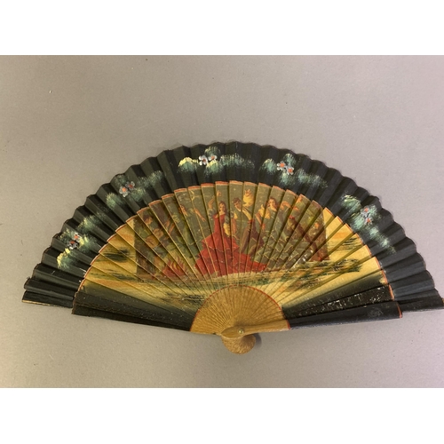 58 - A good, large  c 1890’s bone fan, mounted with a deep silk leaf, painted with an informal gathering ... 