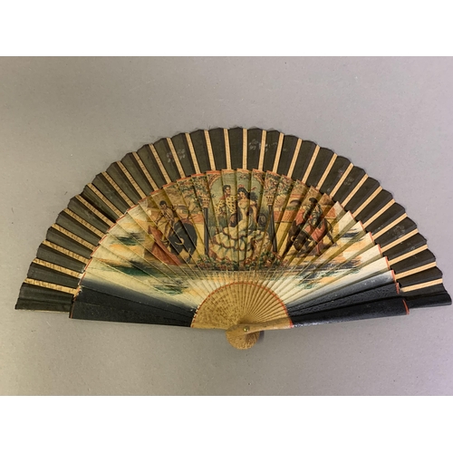 58 - A good, large  c 1890’s bone fan, mounted with a deep silk leaf, painted with an informal gathering ... 