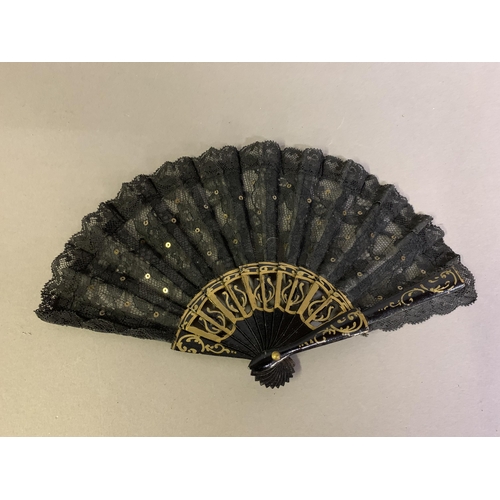 58 - A good, large  c 1890’s bone fan, mounted with a deep silk leaf, painted with an informal gathering ... 