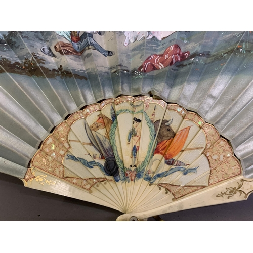 58 - A good, large  c 1890’s bone fan, mounted with a deep silk leaf, painted with an informal gathering ... 