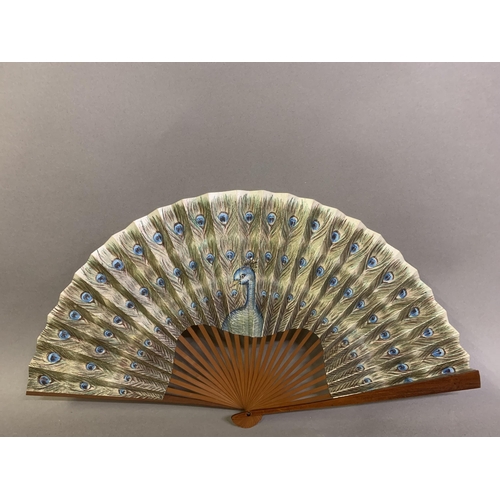 60 - A small 20th century celluloid brisé fan with a faint design of dancers, the lower guard printed wit... 