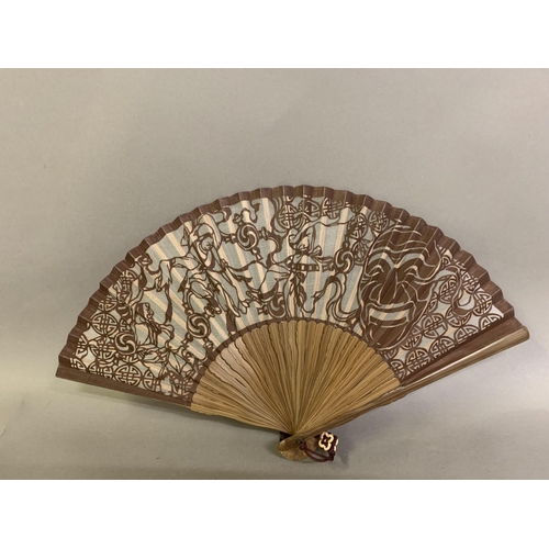 60 - A small 20th century celluloid brisé fan with a faint design of dancers, the lower guard printed wit... 