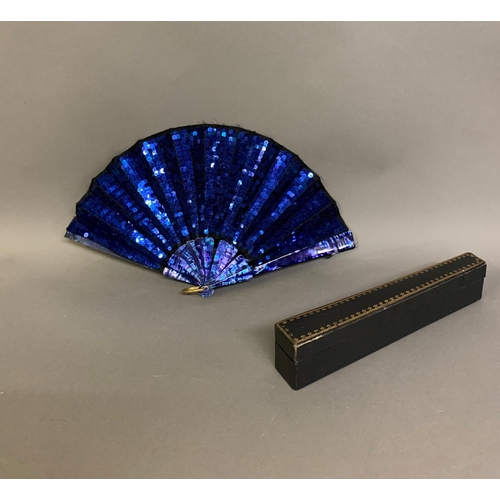 61 - An early 20th century opera fan, the leaf a panel of black gauze covered with bright blue sequins, w... 