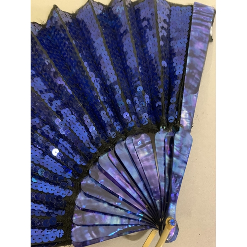 61 - An early 20th century opera fan, the leaf a panel of black gauze covered with bright blue sequins, w... 