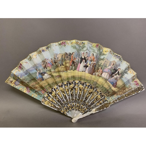 62 - Two mid-19th century mother of pearl fans, both carved, pierced and gilded, the first contained in a... 