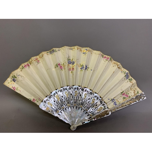 62 - Two mid-19th century mother of pearl fans, both carved, pierced and gilded, the first contained in a... 