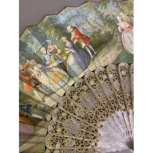 62 - Two mid-19th century mother of pearl fans, both carved, pierced and gilded, the first contained in a... 