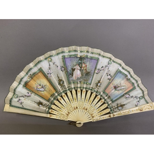 64 - A small bone late 19th century/early 20th century gilded bone fan mounted with the known printed sil... 