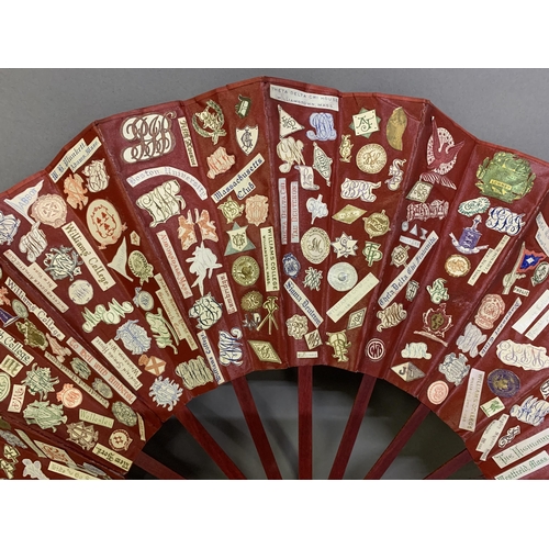 28 - A large and vibrant 19th century scrap fan, the wood sticks, in Japanese style, dyed dull red, the r... 