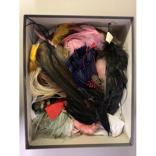 258 - Haberdashery: Four boxes (one being a Harrods hatbox) of millinery and costume feathers, many with t... 