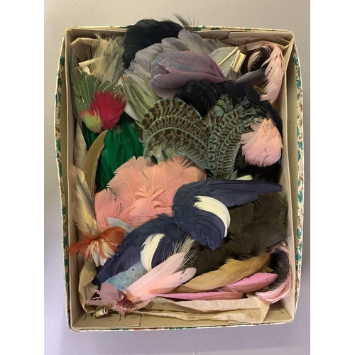 258 - Haberdashery: Four boxes (one being a Harrods hatbox) of millinery and costume feathers, many with t... 