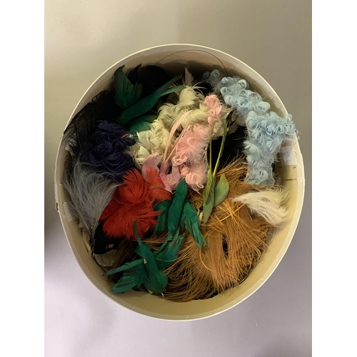 258 - Haberdashery: Four boxes (one being a Harrods hatbox) of millinery and costume feathers, many with t... 