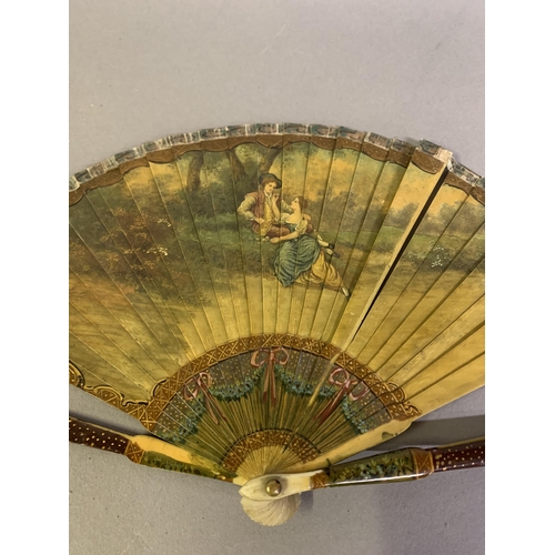 37 - A 19th century Vernis Martin style brisé fan, the recto with a tender scene of a young courting coup... 