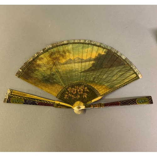 37 - A 19th century Vernis Martin style brisé fan, the recto with a tender scene of a young courting coup... 