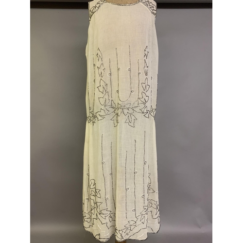 274 - A 1920’s beaded dress, cream cotton embroidered with clear beads, labelled “Made in France”, approx.... 