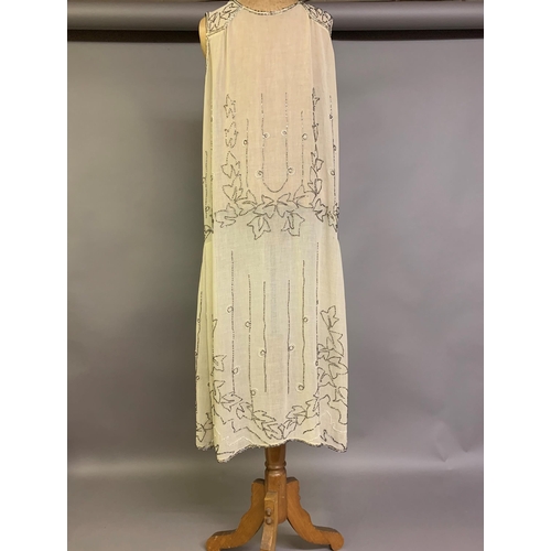 274 - A 1920’s beaded dress, cream cotton embroidered with clear beads, labelled “Made in France”, approx.... 