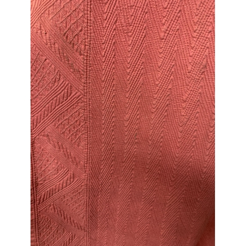 317 - An antique Persian quilted robe, full length, the cotton exterior in strong pink, the interior in cr... 