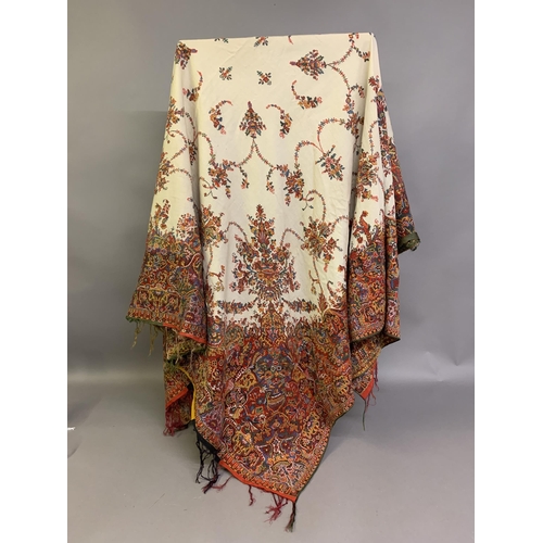 213 - A 19th century square woven shawl, Norwich, with deep borders, designed with flowers in urns to the ... 