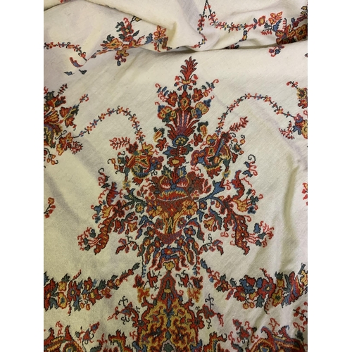 213 - A 19th century square woven shawl, Norwich, with deep borders, designed with flowers in urns to the ... 