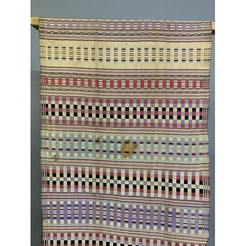 322 - A very fine quality long silk shawl, fringed to the long ends, woven in narrow bands with complex de... 