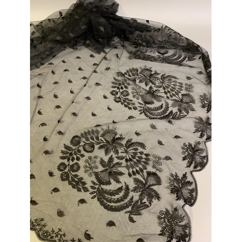 191 - Black silk tamboured lace bonnet veil, early 1900’s, the dep bottom border worked with four large fo... 