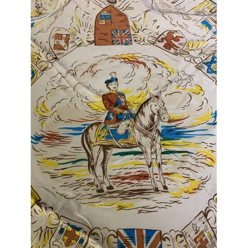 243 - A Queen Elizabeth II commemorative scarf, cream background printed in vivid colours with a young Que... 