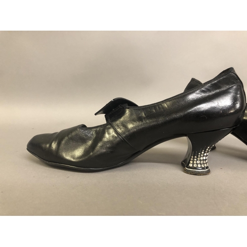 237 - Early 1920’s black leather shoes fitted with diamanté inset heels, the front bar on elastic and ador... 