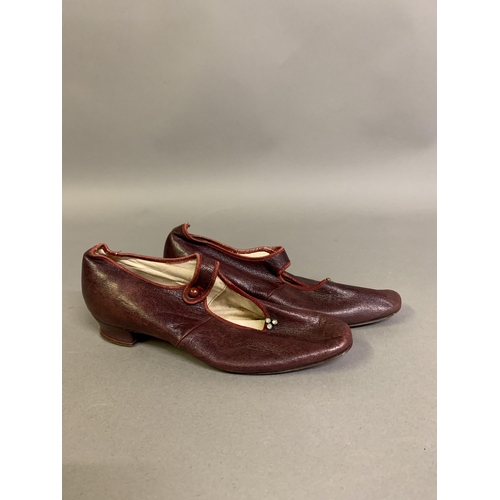 250 - A pair of 19th century young girl’s shoes, in ruby leather, small leather-covered heel, front bar wi... 