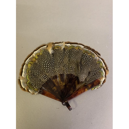 106 - A 19th century small marquetry game bird feather fan, layered from speckled to cream to bi-colour br... 