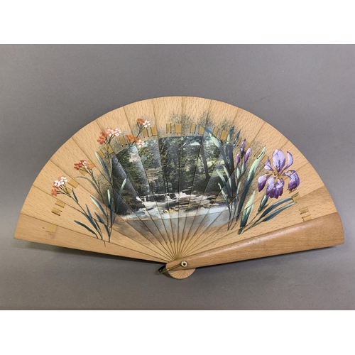 21 - A late 19th century wood brisé fan, with a central applied scenic panel of a rural bridge and waterf... 