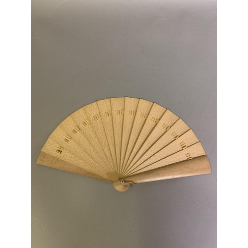 21 - A late 19th century wood brisé fan, with a central applied scenic panel of a rural bridge and waterf... 