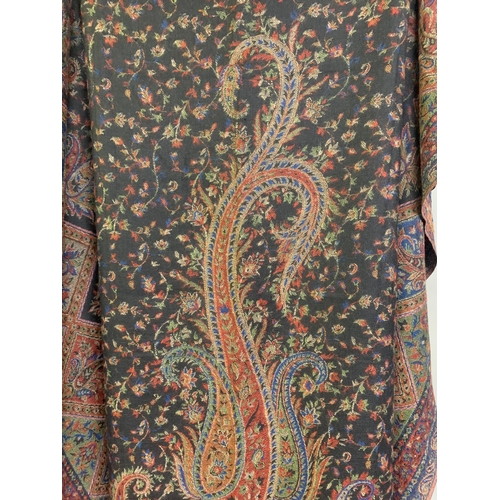 233 - Two panels from a 19th century woven paisley shawl, cut in shield-shape following the design, each a... 