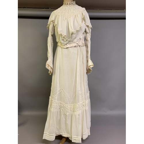 214 - A cream Edwardian two-piece costume, the high-necked bodice boned, with waist tie, an inside panel w... 