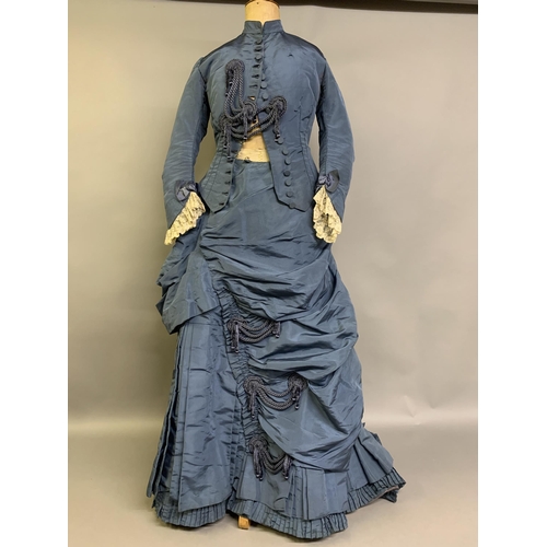 215 - A c 1880’s teal silk two-piece costume, the fitted bodice with narrow shaped sleeves, machine lace a... 