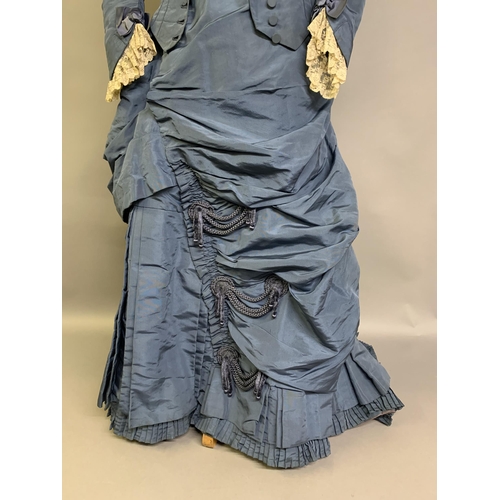 215 - A c 1880’s teal silk two-piece costume, the fitted bodice with narrow shaped sleeves, machine lace a... 