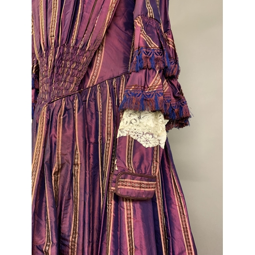 218 - A fine and unusual striped purple silk dress c 1850’s, with tiered pagoda sleeves, finished with sil... 