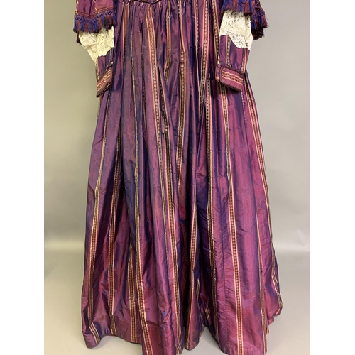 218 - A fine and unusual striped purple silk dress c 1850’s, with tiered pagoda sleeves, finished with sil... 